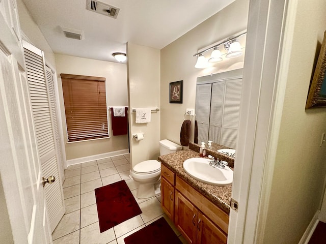 bathroom with vanity, tile patterned floors, and toilet