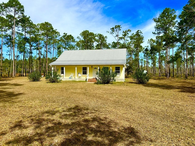 view of front of property with covered porch and a front lawn