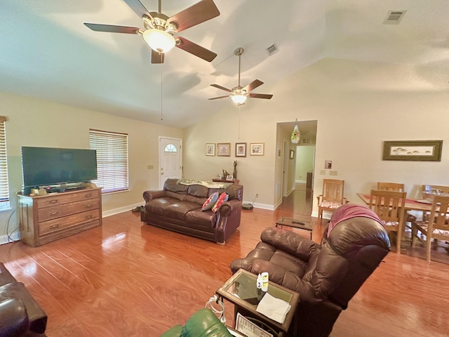 living room featuring hardwood / wood-style flooring, high vaulted ceiling, and ceiling fan