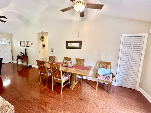 dining space with hardwood / wood-style flooring, ceiling fan, and high vaulted ceiling