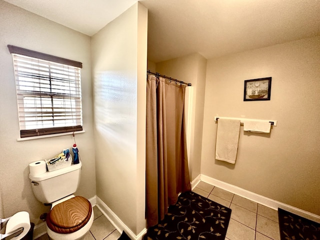 bathroom featuring tile patterned flooring and toilet