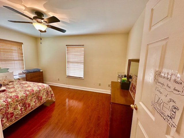 bedroom with dark wood-type flooring and ceiling fan