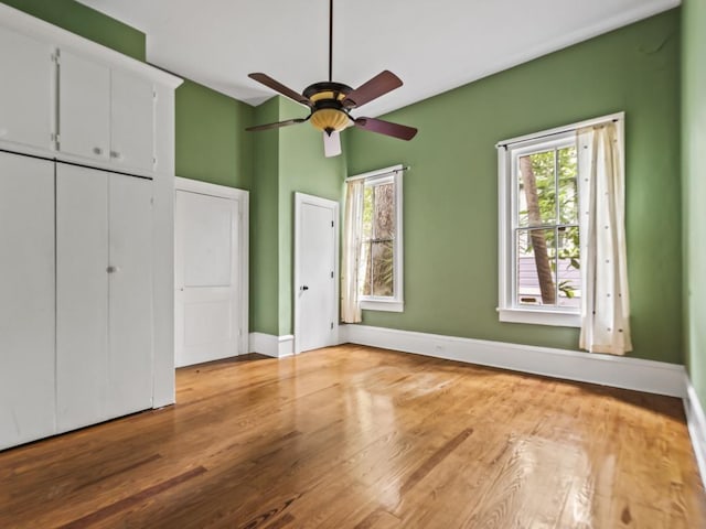 unfurnished bedroom featuring hardwood / wood-style flooring and ceiling fan