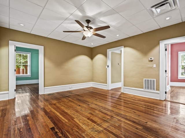 spare room featuring hardwood / wood-style flooring, a paneled ceiling, and ceiling fan