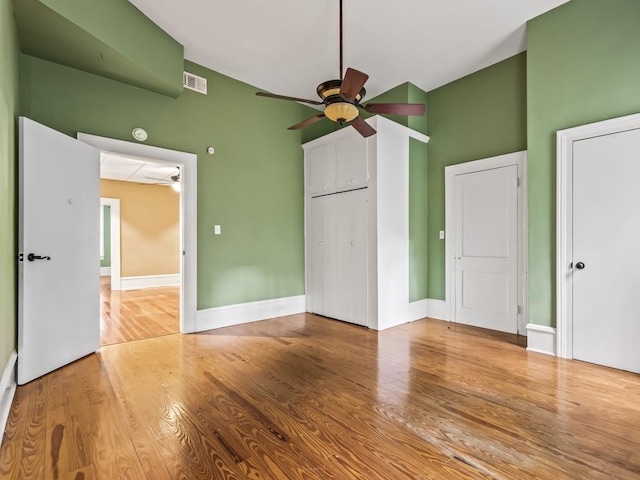 unfurnished bedroom with wood-type flooring and a closet