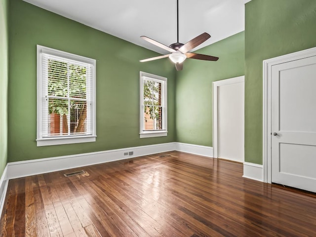 interior space with dark wood-type flooring and ceiling fan