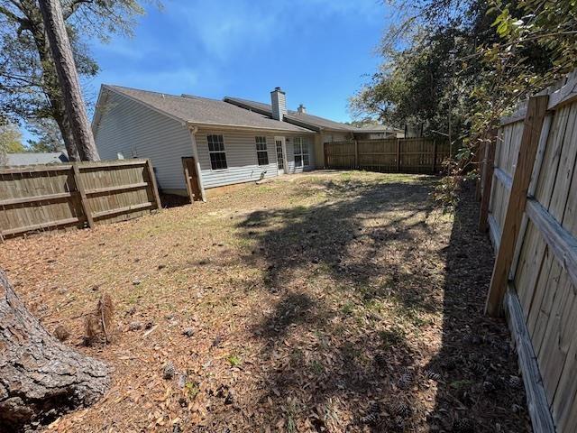 7102 Towner Trce, Tallahassee, FL 32312 - view of yard featuring central AC and fence