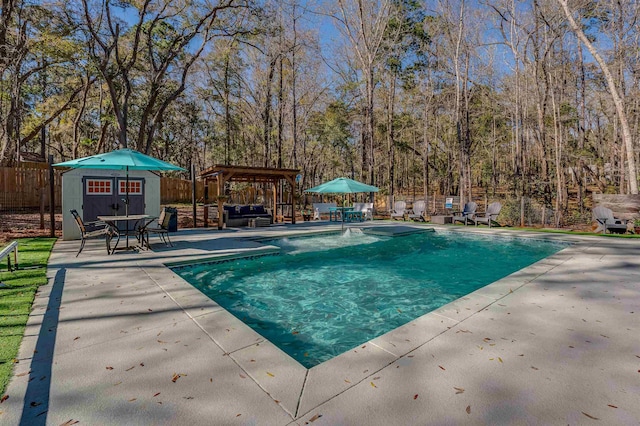 view of pool featuring an outbuilding, a fenced backyard, outdoor lounge area, and a patio area