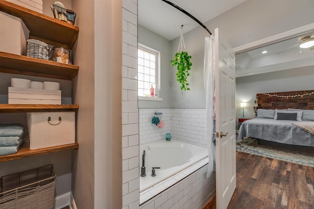 full bath with ensuite bath, a garden tub, and wood finished floors