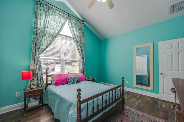 bedroom with visible vents, baseboards, wood finished floors, and vaulted ceiling