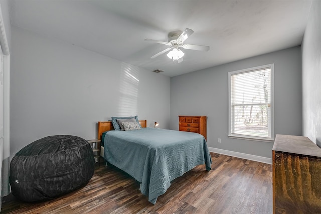 bedroom featuring ceiling fan, visible vents, baseboards, and dark wood finished floors