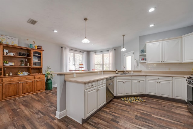 kitchen with visible vents, open shelves, a sink, a peninsula, and dishwasher