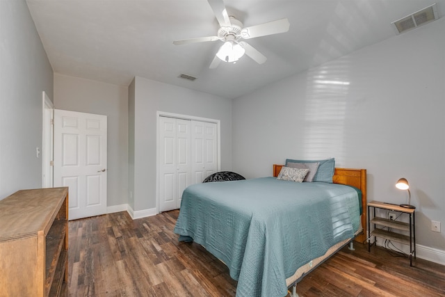 bedroom with visible vents, baseboards, a closet, and wood finished floors