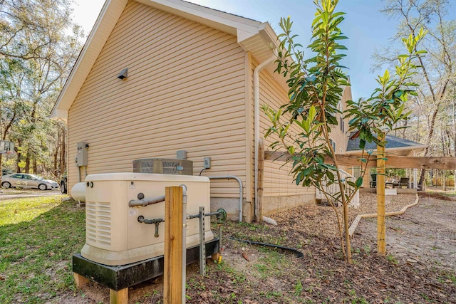 view of side of home with central AC unit