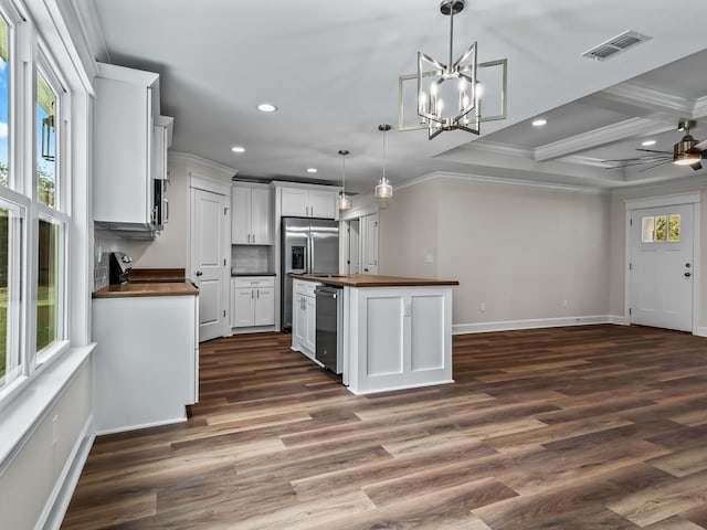 kitchen with a kitchen island, visible vents, white cabinetry, wooden counters, and decorative light fixtures