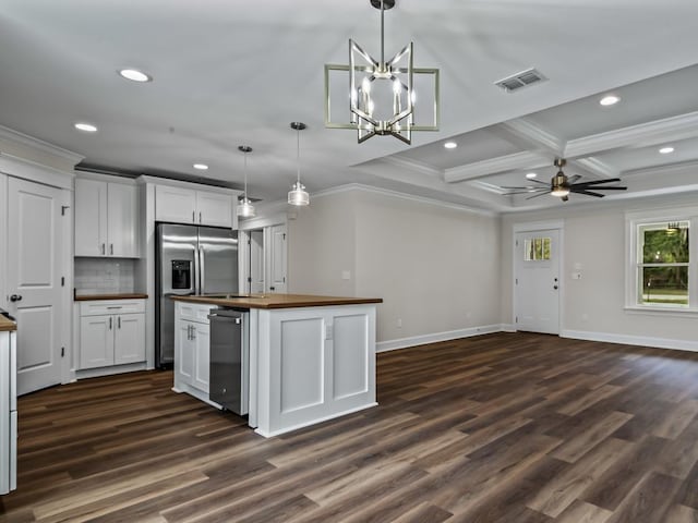 kitchen featuring pendant lighting, butcher block counters, white cabinets, and visible vents