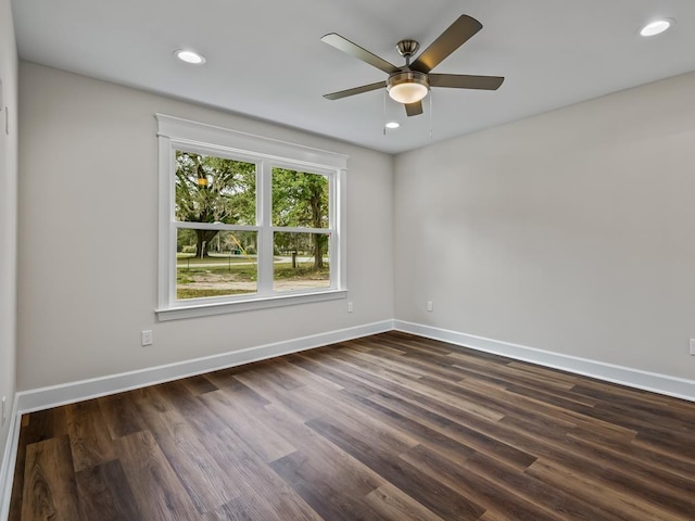 unfurnished room with recessed lighting, dark wood finished floors, and baseboards