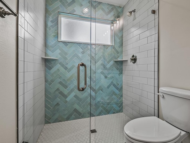 bathroom featuring a shower stall and toilet