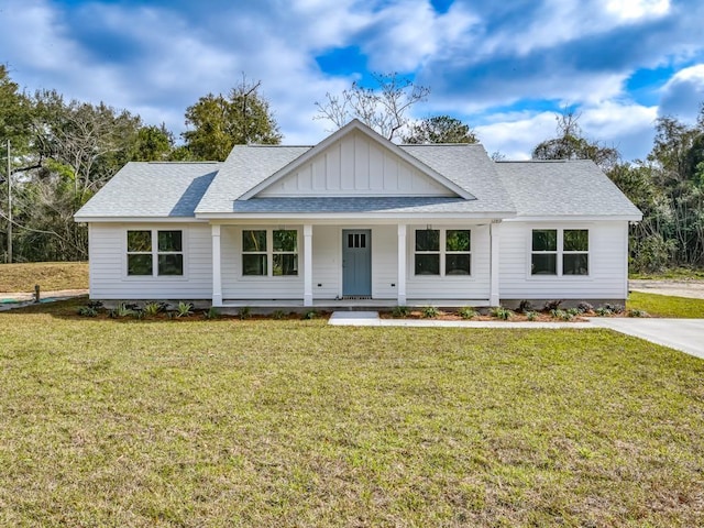 modern farmhouse style home with roof with shingles, a front lawn, board and batten siding, and a porch