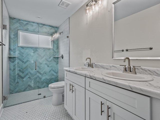 bathroom featuring double vanity, a sink, visible vents, and a shower stall