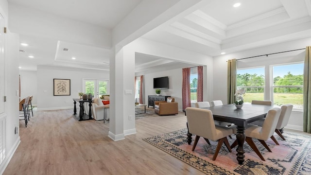 dining area featuring ornamental molding and light wood-type flooring