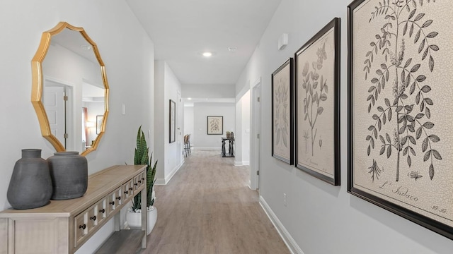 hallway with light hardwood / wood-style flooring