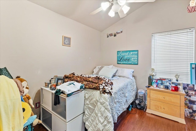 bedroom with ceiling fan, dark hardwood / wood-style flooring, and vaulted ceiling