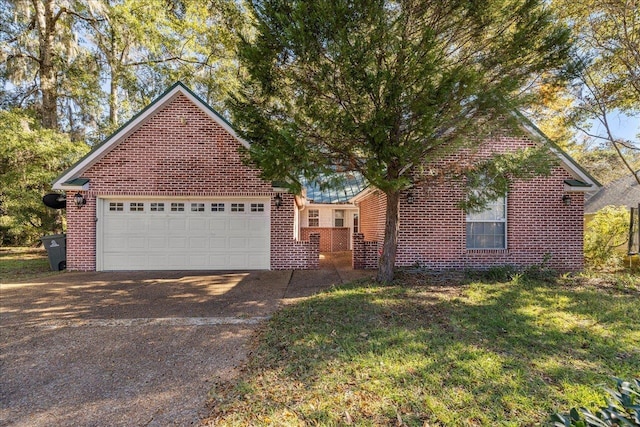 view of front of house featuring a front yard and a garage