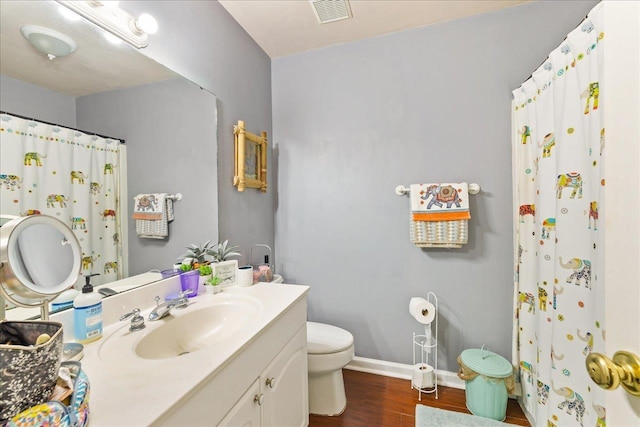 bathroom with hardwood / wood-style floors, vanity, and toilet