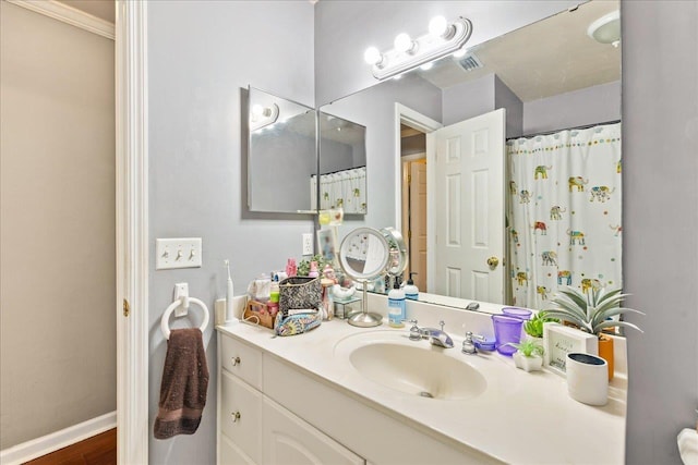 bathroom featuring a shower with curtain, vanity, wood-type flooring, and ornamental molding