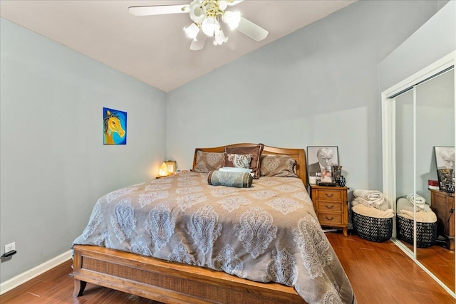 bedroom with wood-type flooring, a closet, ceiling fan, and lofted ceiling