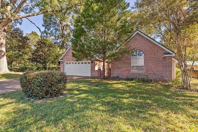 view of front of home with a front yard and a garage