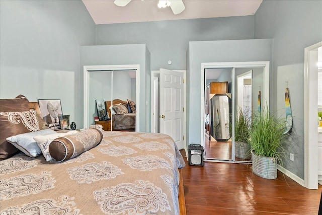 bedroom with ceiling fan, dark wood-type flooring, and vaulted ceiling