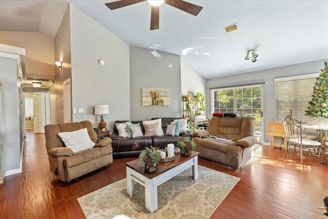 living room with ceiling fan, dark wood-type flooring, and lofted ceiling