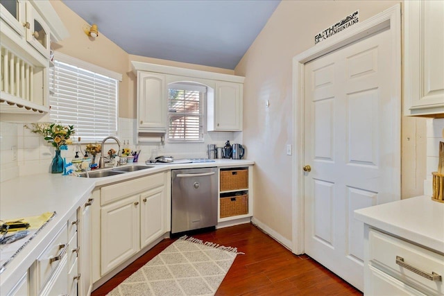 kitchen with stainless steel dishwasher, dark hardwood / wood-style flooring, white cabinets, and sink