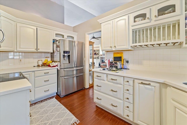 kitchen featuring stainless steel fridge, backsplash, dark hardwood / wood-style flooring, ceiling fan, and white cabinets