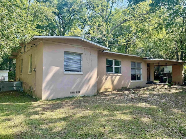 1402 W Tharpe St, Tallahassee, FL 32303 - view of property exterior with a lawn, crawl space, and stucco siding