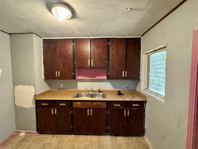 1402 W Tharpe St, Tallahassee, FL 32303 - kitchen featuring a textured ceiling, light countertops, and dark brown cabinets