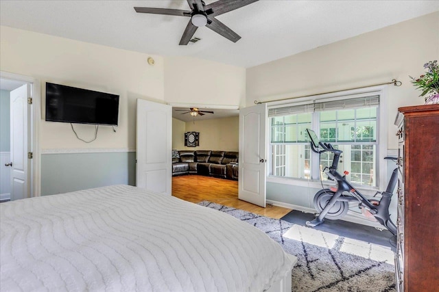 bedroom with ceiling fan, light wood-type flooring, and visible vents