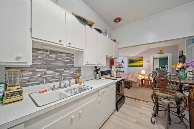 kitchen featuring white cabinetry, sink, range with electric cooktop, crown molding, and decorative backsplash