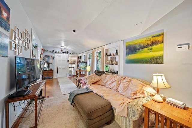 living room featuring lofted ceiling and hardwood / wood-style floors