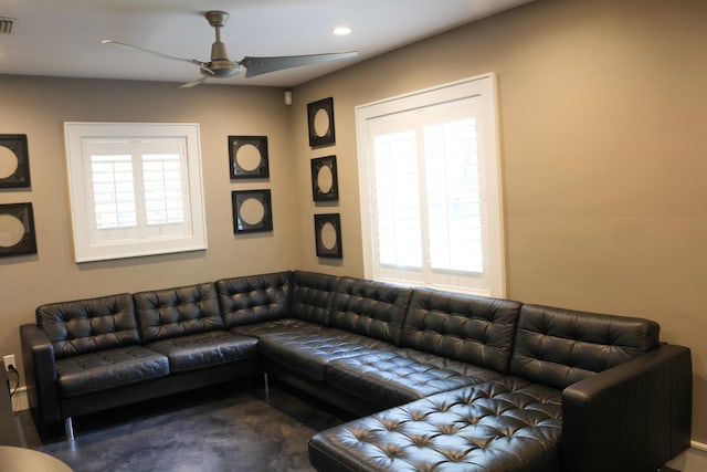 living room with ceiling fan and plenty of natural light