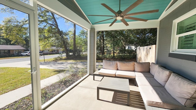 unfurnished sunroom with vaulted ceiling and ceiling fan