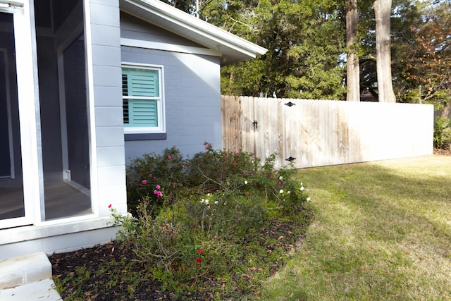 view of side of home with a yard