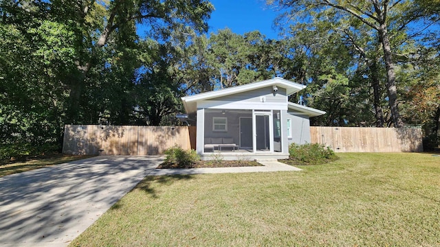 exterior space featuring a front yard and a sunroom