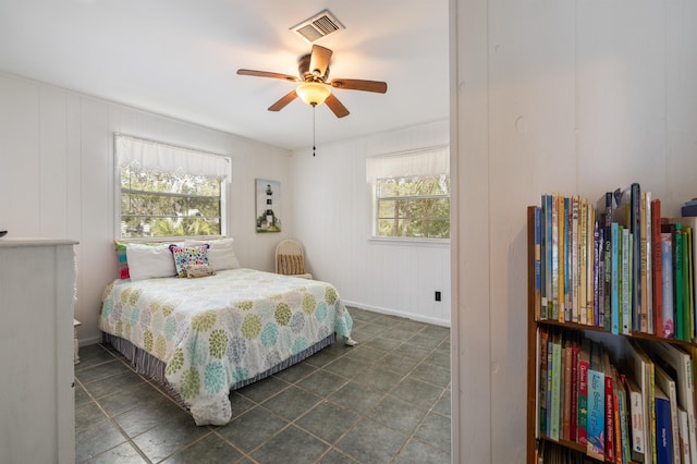 bedroom featuring ceiling fan and multiple windows