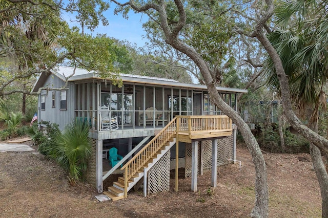 rear view of property featuring a sunroom