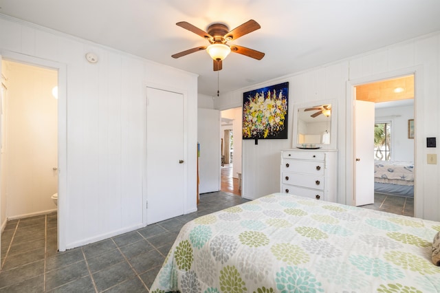 bedroom featuring ensuite bath and ceiling fan