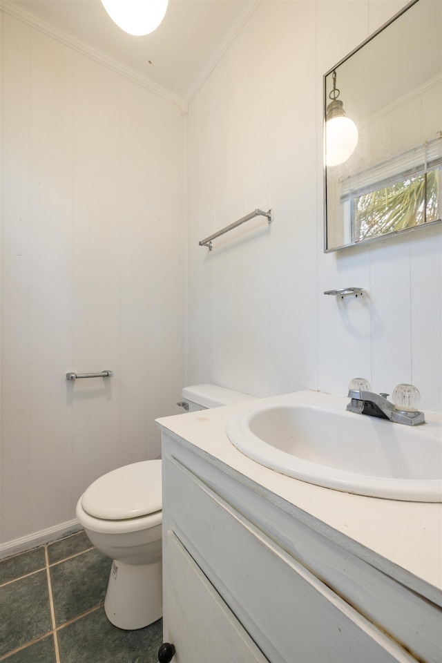 bathroom featuring toilet, tile patterned flooring, crown molding, and vanity