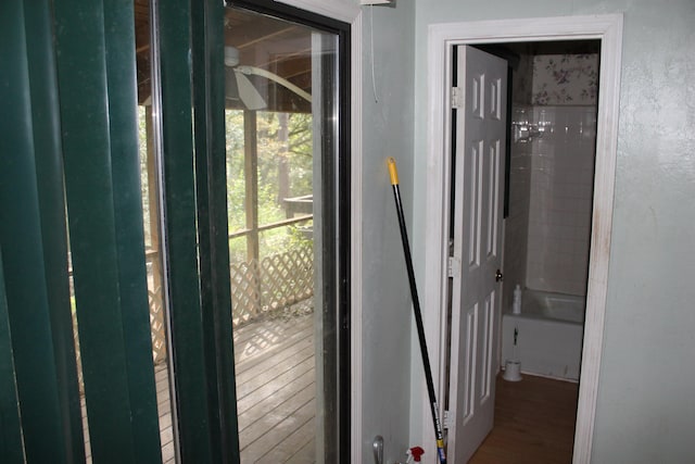 doorway featuring a textured wall and wood finished floors